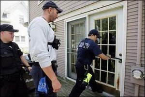 Click to enlarge Police breaking into a home