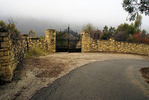 Security gates still stand at the former entrance to the compound