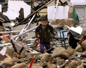 Palestinian child on demolished home