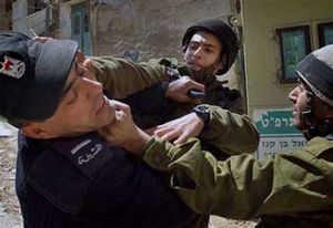 Israeli soldiers beating a Palestinian Police.
