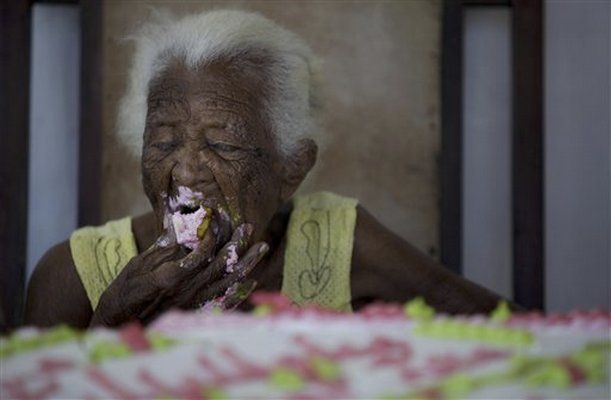 Juana Bautista de la Candelaria Rodriguez eats cake during her birthday 