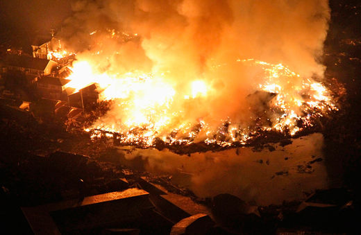 Click to enlarge Houses burn at night