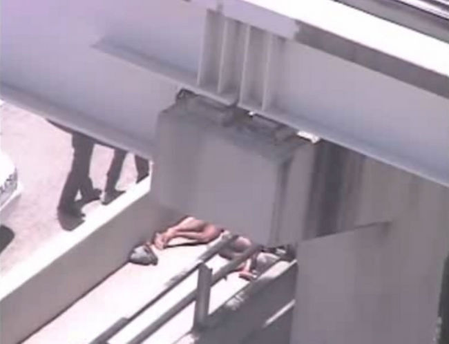 A surveillance camera on the Miami Herald building partly shows two pairs of