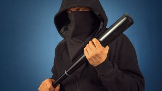 masked man with baseball bat