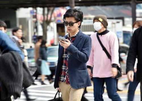 A pedestrian using his smartphone