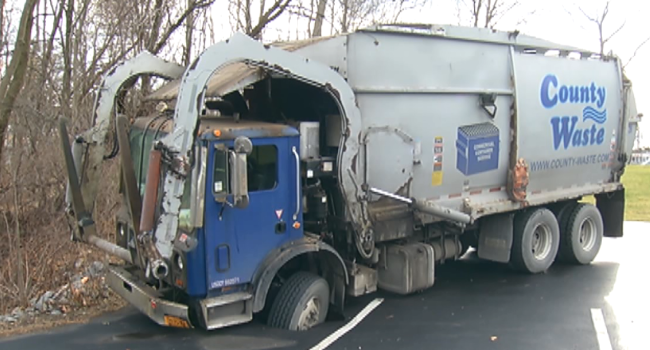Garbage truck in sinkhole