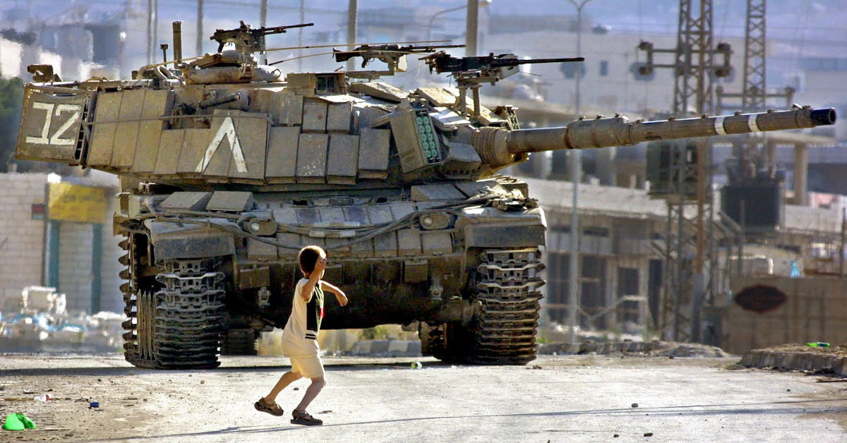 palestinian boy throws rock at israeli tank