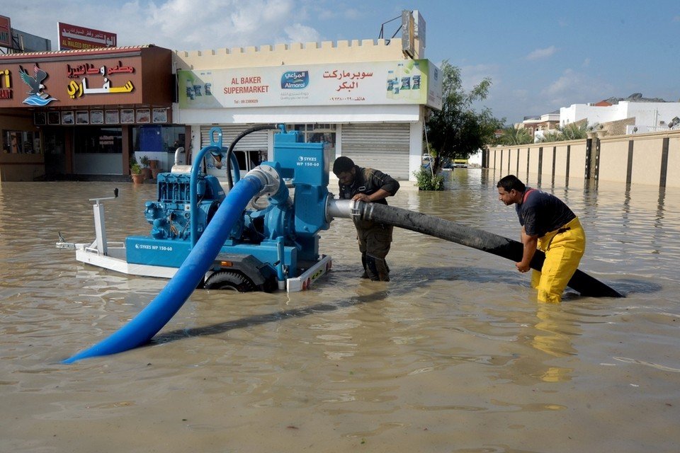 Workers pump away floodwater after the rainstorm in Qirfa, Fujairah. 