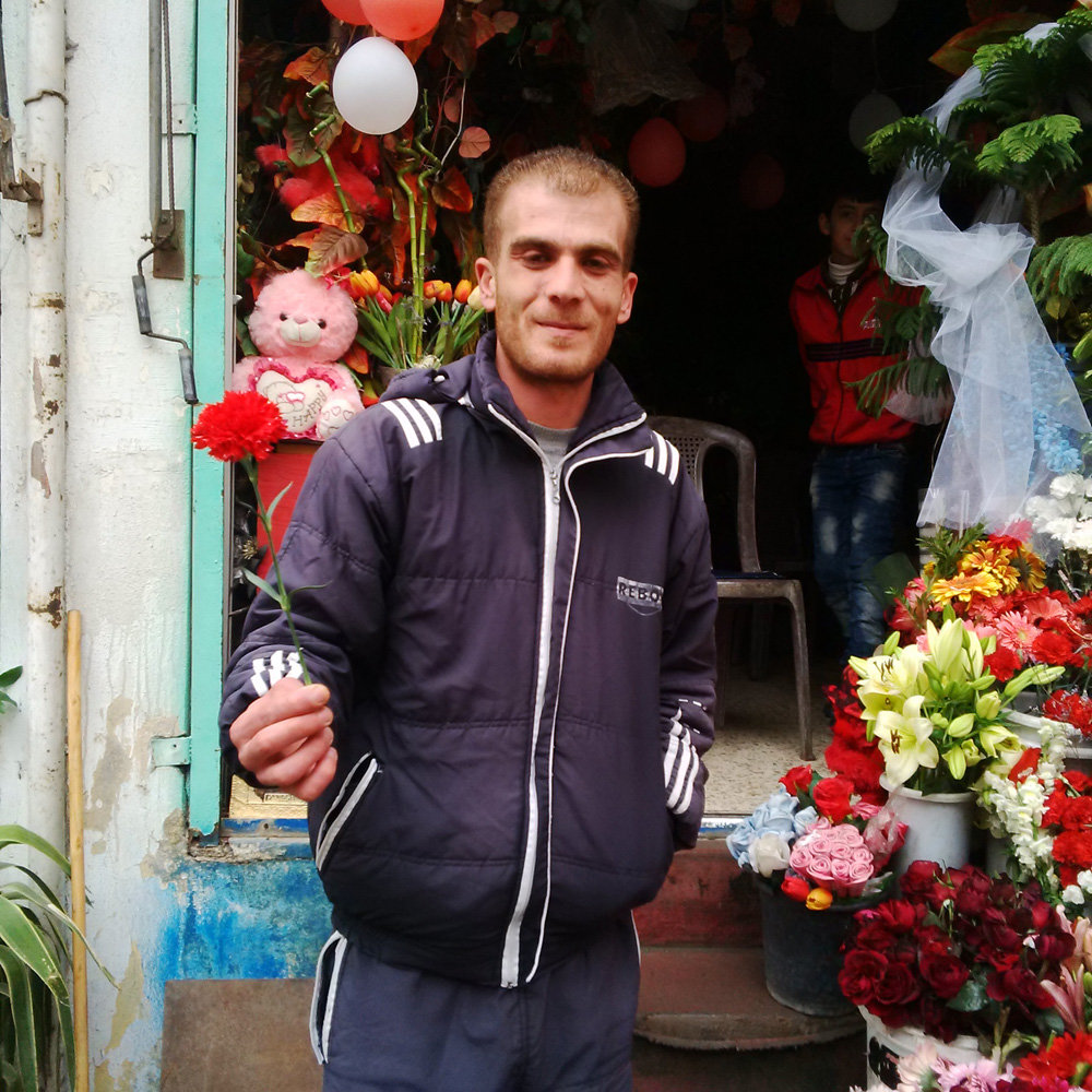 Click to enlarge A flower vendor in Sweida