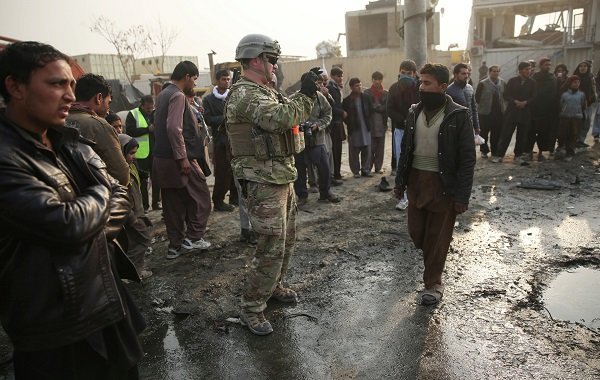 A US soldier at the site of a suicide car bomb attack in Kabul, Afghanistan.