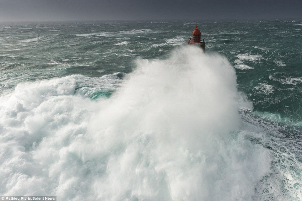 Click to enlarge After the wave crashed into the lighthouse, the sea surrounding it was whipped up into a white-water frenzy