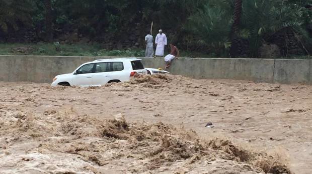A taxi washed away by floodwaters smashes into a four-wheel-drive during heavy rains in Oman on Friday. 