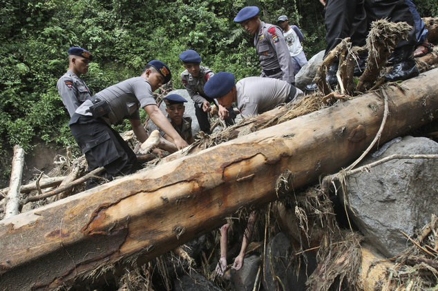 Rescuers recover the body of a victim after a flood hit Dua Warna waterfall in Sibolangit, North Sumatra, Indonesia, Monday, May 16, 2016. Nearly two dozen students were missing in rain-triggered floods and landslides at the waterfall which is popular tou