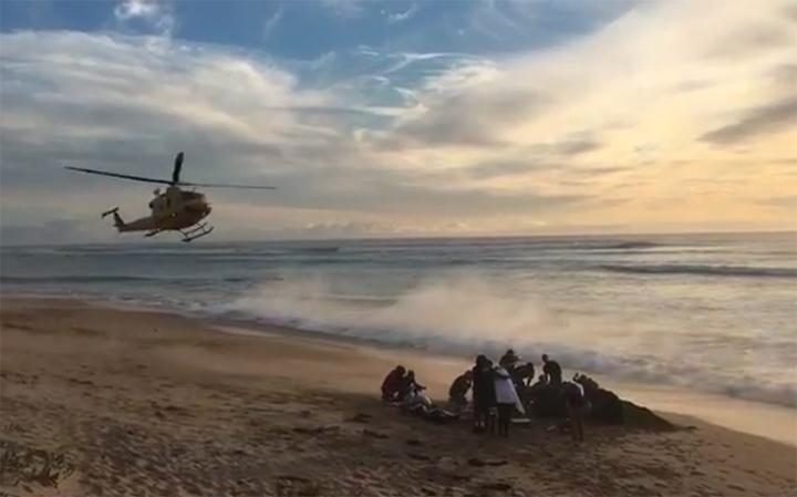  Emergency services tend to the injured surfer 