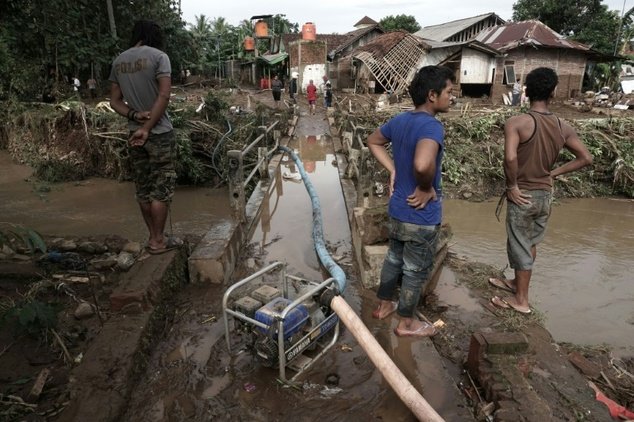 Flash floods and landslides in central Indonesia have killed at least 35 people and destroyed dozens of homes as searchers scoured devastated villages for survivors.
