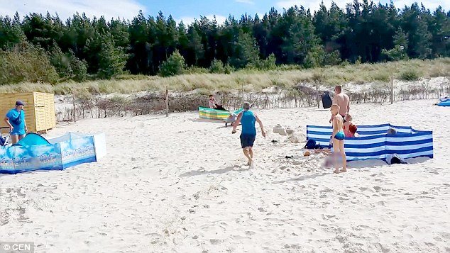 Incredible footage shows the beast knocking people over their chairs and sand castles before taking down nearby women and children