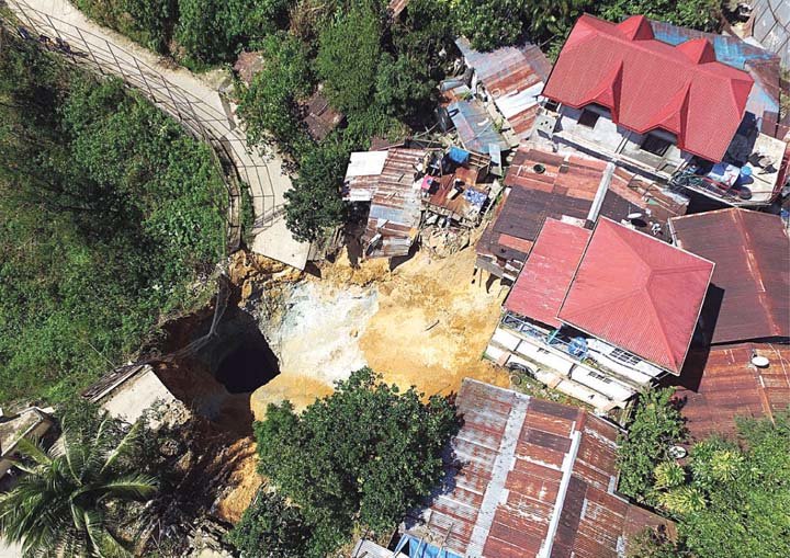 Shown in this handout photo from the Office of Civil Defense-Cordillera Administrative Region (OCD-CAR) is the sinkhole area in Sitio Batuang, Barangay Virac, Itogon, Benguet, just 18 kilometers outside of Baguio City.