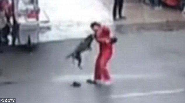 The man hits the dog as it continues to bite him in the arm during its two-hour rampage