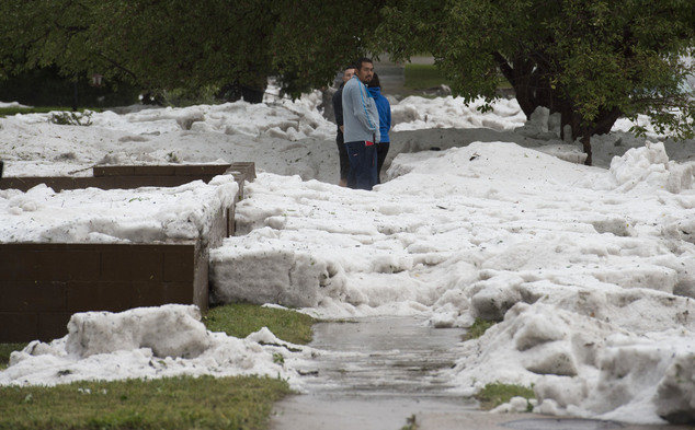 Hail as deep as two feet lies in the front yards of home along Logan Avenue between Platte Avenue and Bijou Street after a storm hit Colorado Springs, Colo., Monday, Aug. 29, 2016. 