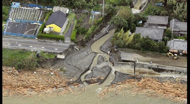 Photo taken Sept. 20, 2016, from a Kyodo News airplane shows a collapsed bridge in the southwestern Japan city of Tarumizu, hit by Typhoon Malakas