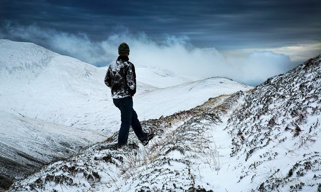 Man walks in Scotland snow
