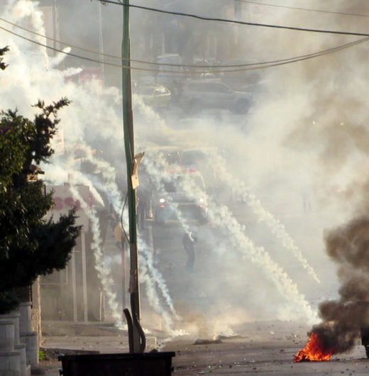 The IDF attacks the area between the ‘Azza and Aida refugee camps, Bethlehem, as an ambulance (center, background) tries to rescue victims. December, 2015