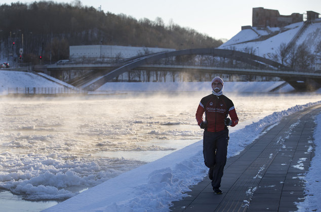 A man with frost on his face runs along the bank of the Neris river as temperatures dipped to -21 degrees Celsius (-5.8 degrees Fahrenheit) in Vilnius, Lithuania, Friday, Jan. 6, 2017. 