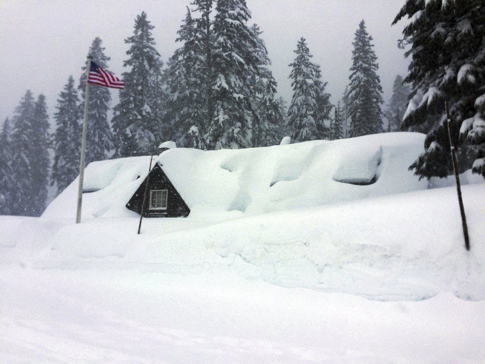  This Tuesday, Jan. 10, 2017 photo provided by the U.S. National Park Service shows the Crater Lake National Park visitor center in Oregon buried in snow up to the eaves as severe weather forced the southern Oregon park's closure. 