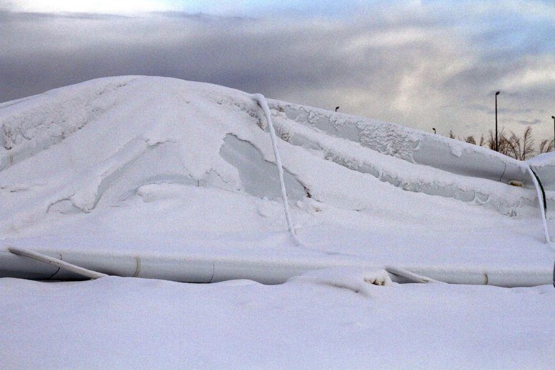Snow sits on the collapsed roof of The Dome, a 180,000-square foot indoor sports facility in Anchorage, Alaska, on Tuesday after the roof collapsed in a snowstorm.