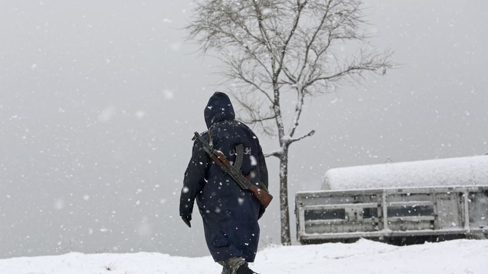 A security officer walks through snow on the Nadir Khan Hill in Kabul, Afghanistan.