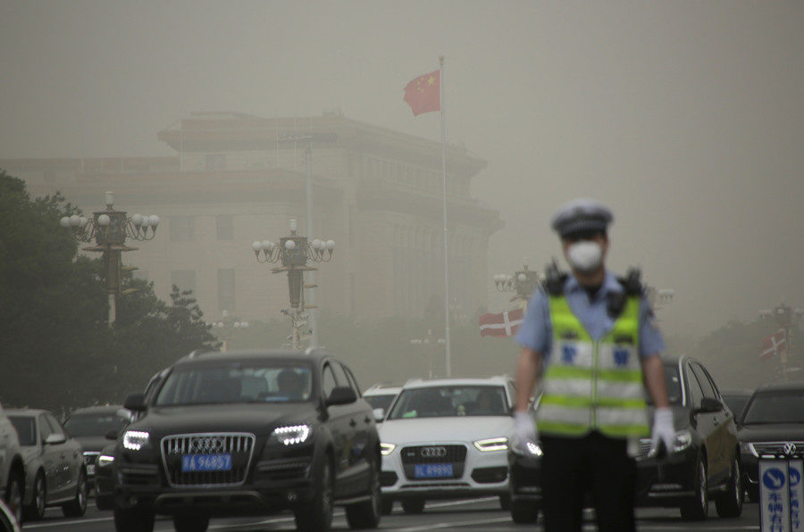 The Great Hall of the People is seen as a dust storm hits Beijing