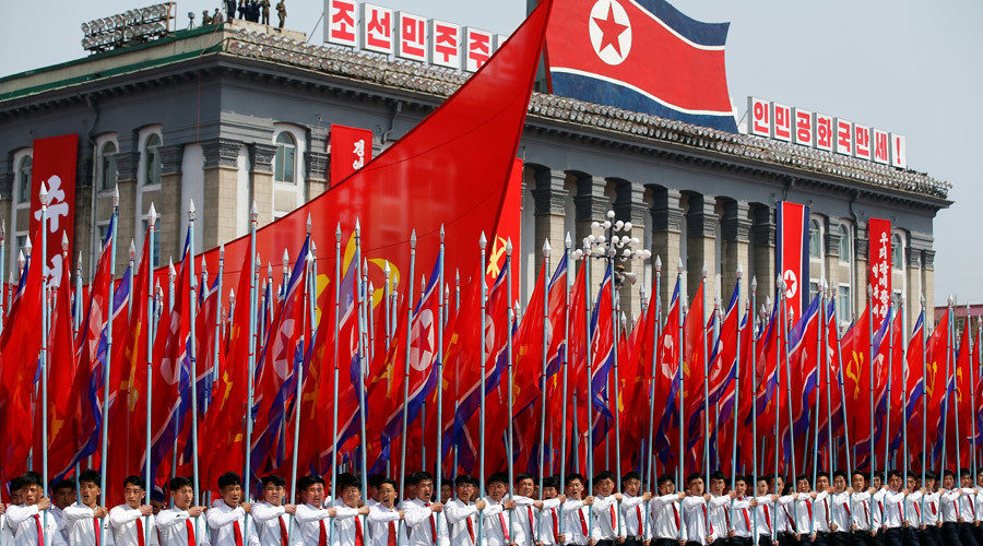North Korean people holding flags