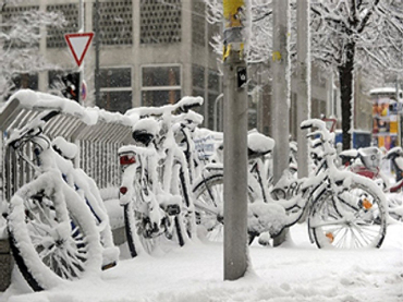 snow-covered bicycles