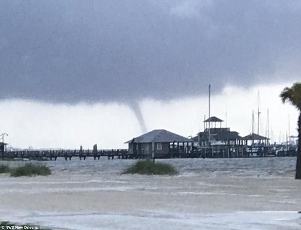 To make matters worse, a tornado watch was issued from Louisiana to Florida, and cyclones were spotted across Mississippi on Wednesday (pictured, a watersprout in Biloxi, MS) 