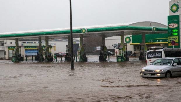 Flood water filled the petrol station forecourt.