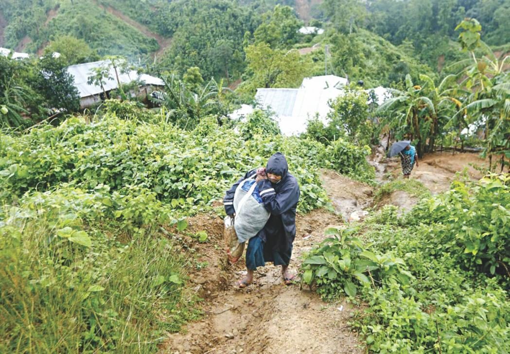This STAR file photo shows a man leaves his home in a valley with a sack full of belongings in Rupnagar of Rangamati after incessant rain posed the risk of more landslides in the hilly district.
