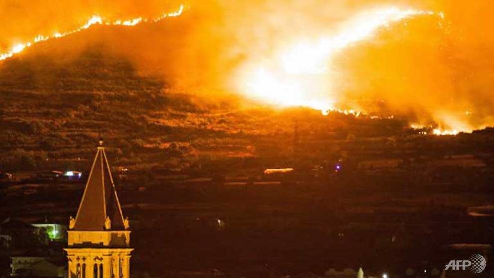 A fire rages in Trogir, Croatia, as firefighters battle several large blazes along the Adriatic coast
