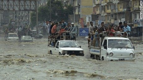 Pakistani commuters travel on a flooded street following a heavy rainfall in Karachi, Pakistan, Thursday, Aug. 31, 2017
