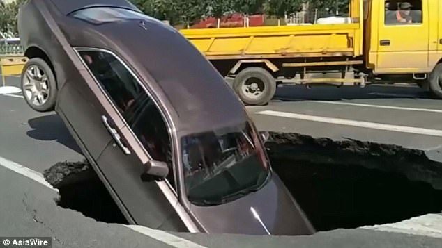 A Rolls-Royce Phantom fell into a massive sinkhole in northern China's Harbin on October 1