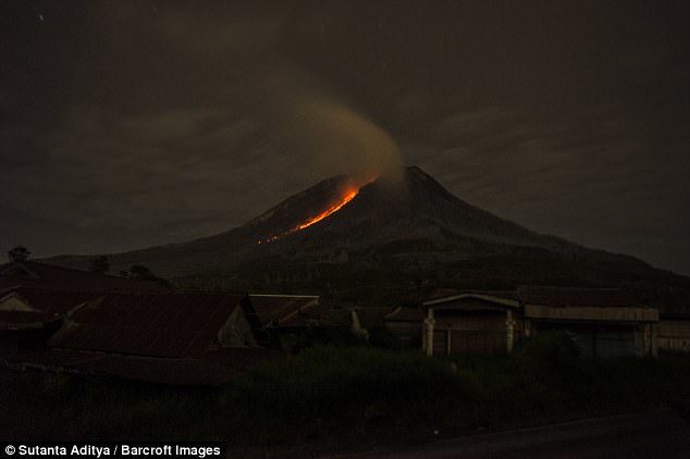 Lava flows from crater of Mount Sinabung during an eruption in Karo, Indonesia, on Sunday