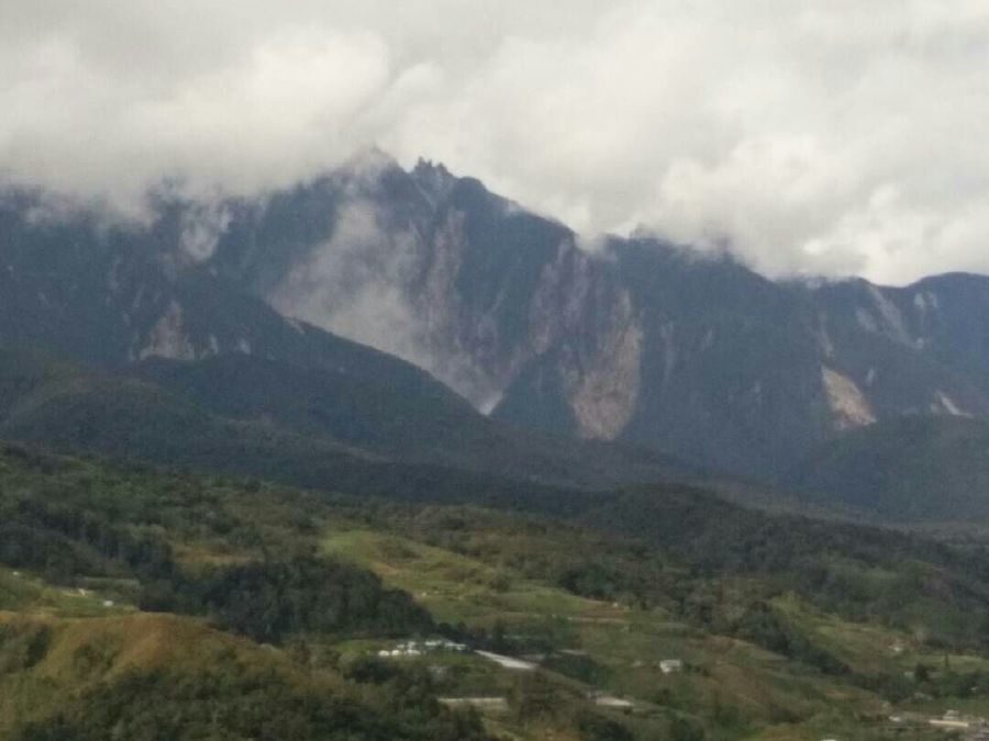 A massive landslide swept down the foothills of Mount Kinabalu this afternoon, triggering panic among the locals here.