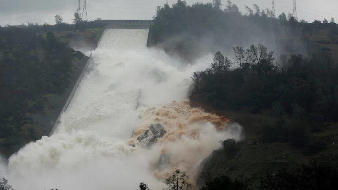 Water flows through break in the wall of the Oroville Dam spillway during heavy rains on Thursday, Feb. 9, 2017.