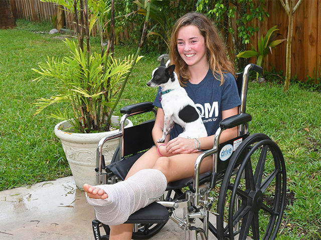 Kaia Anderson, 14, of Floridana Beach (south of Melbourne Beach) was bitten by a shark this past Saturday while surfing. While being interviewed, their dog Spot wanted to be in the photo.