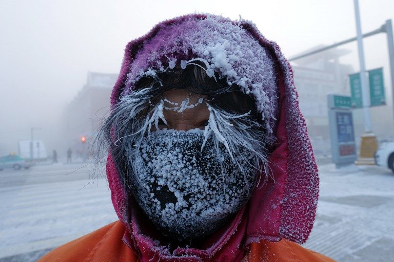 This photo taken on January 24, 2018 shows ice forming on the face of a Chinese sanitation worker on a cold winter day in Hulun Buir, northern China’s Inner Mongolia region.