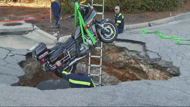 Motorcyclist falls into sinkhole