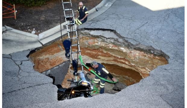 Man, motorcycle fall into Augusta Exchange shopping center sinkhole