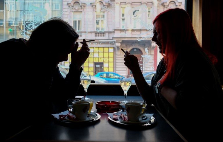 Café guests smoke cigarettes with their drinks in Vienna on March 22nd 2018.