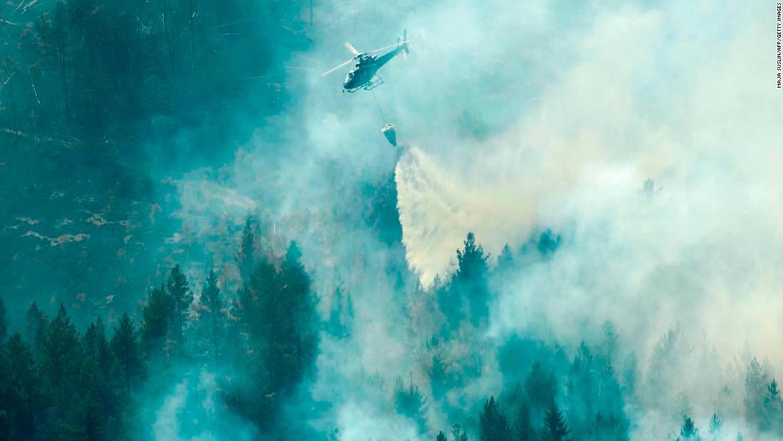 Firefighters use a helicopter to tackle a forest fire Wednesday near Ljusdal in central Sweden.