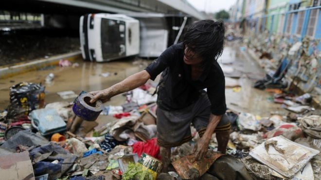 One of many residents of Marikina city combing through the muddy flood aftermath.