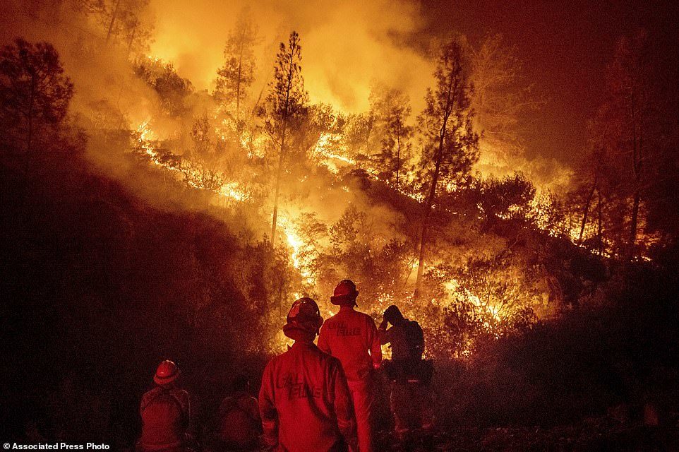 Firefighters monitor a backfire while battling the Ranch Fire, part of the Mendocino Complex Fire near Ladoga, Calif.